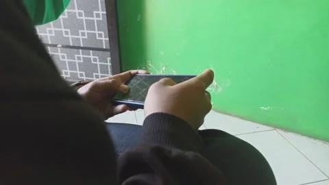 A man is playing a game on a smartphone Stock Footage 243562263