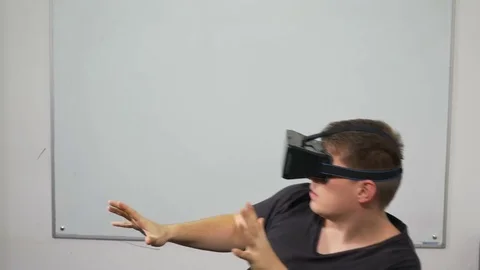 Man playing a game using virtual reality glasses Stock Footage 71475070