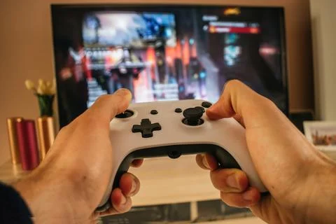 Man playing with gamepad console Stock Photos