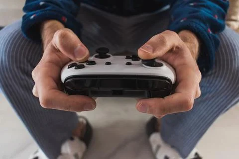 Man playing with a gamepad console Stock Photos