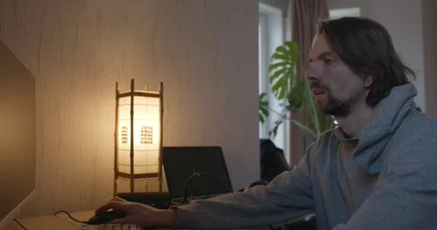Man is Playing Games on Computer. 4K 10-bit Stock Footage 321320343