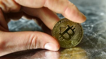 Man playing with gold btc bitcoin in his hands, cryptocurrency Stock Footage 85683940