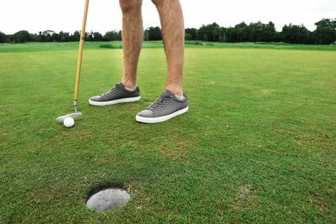 Man playing golf on green course. Sport and leisure Photos