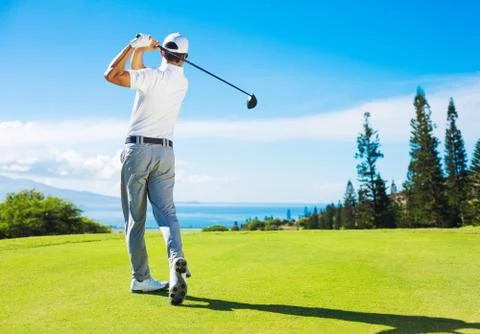 Man playing golf, hitting ball from the tee Stock-Fotos