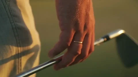 Man playing golf at sunset 2 Stock Footage 12337408