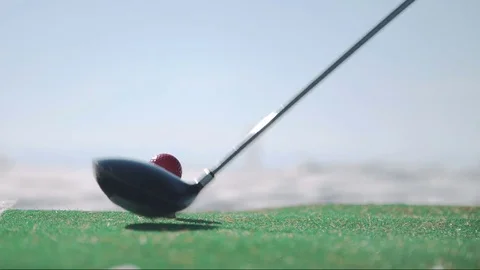 Man playing golf using synthetic grass carpet in winter outdoors Stock Footage 75316439