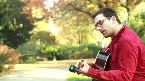 Man playing the guitar and singing Stock Footage 59556430