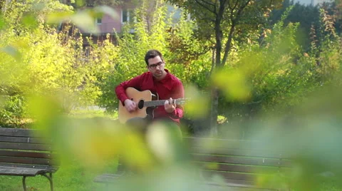 Man playing the guitar and singing Stock Footage 59556438