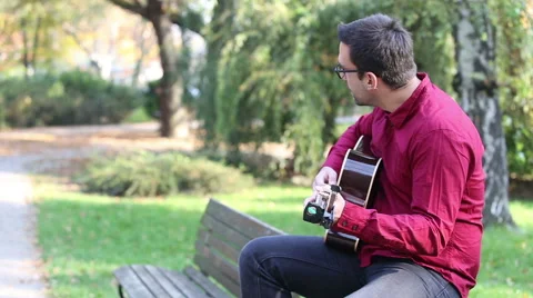 Man playing the guitar and singing Stock Footage 59556500