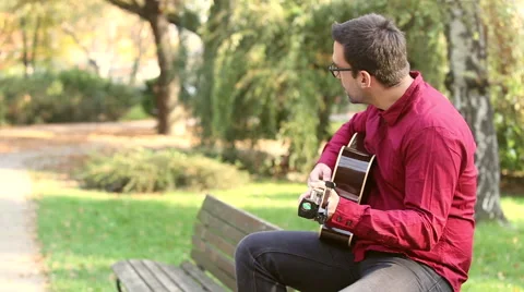 Man playing the guitar and singing Stock Footage 59556505