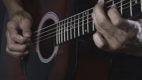 Man playing guitar on black background. Six strings. Playing with fingers Stock Footage 79018896