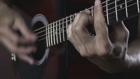Man playing guitar on black background. Six strings. Playing with fingers Stock Footage 79019250