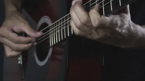 Man playing guitar on black background. Six strings. Playing with fingers Stock Footage 79019757