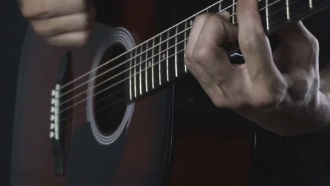 Man playing guitar on black background. Six strings. Playing with fingers Stock Footage 79019781
