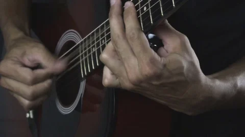 Man playing guitar on black background. Six strings. Playing with fingers Stock Footage 79021041