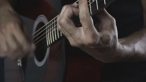 Man playing guitar on black background. Six strings. Playing with fingers Stock Footage 79022256