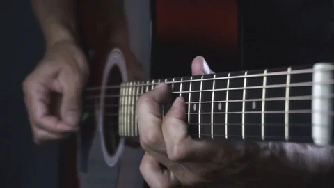 Man playing guitar on black background. Six strings. Playing with fingers Stock Footage 79022454
