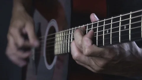 Man playing guitar on black background. Six strings. Playing with fingers Stock Footage 79022827