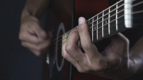 Man playing guitar on black background. Six strings. Playing with fingers Stock Footage 79023774