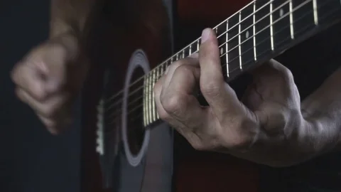 Man playing guitar on black background. Six strings. Playing with fingers Stock Footage 79024107