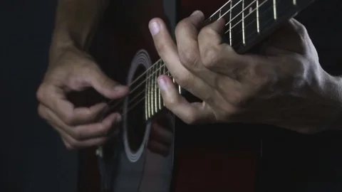 Man playing guitar on black background. Six strings. Playing with fingers Stock Footage 79024518