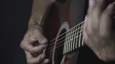 Man playing guitar on black background. Six strings. Playing with fingers Stock Footage 79027779