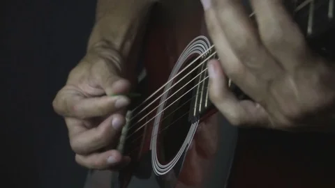 Man playing guitar on black background. Six strings. Playing with fingers Stock Footage 79028028