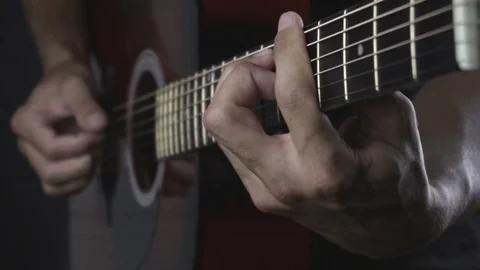 Man playing guitar on black background. Six strings. Playing with fingers Stock Footage 79028710