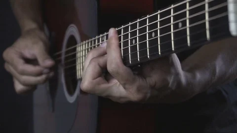 Man playing guitar on black background. Six strings. Playing with fingers Stock Footage 79029135