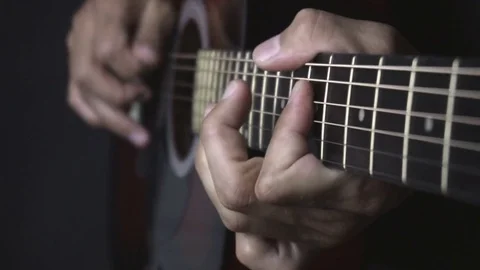 Man playing guitar on black background. Six strings. Playing with fingers Stock Footage 79030238
