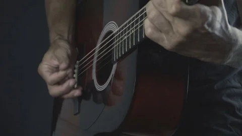 Man playing guitar on black background. Six strings. Playing with fingers Video stock 79033112