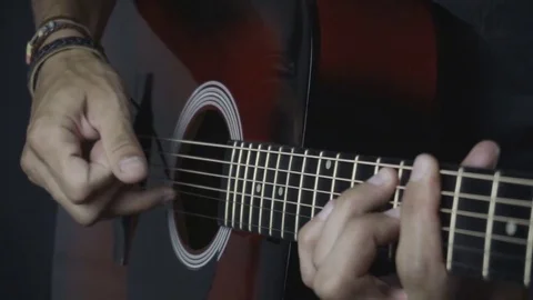 Man playing guitar on black background. Six strings. Playing with fingers Stock Footage 79038323