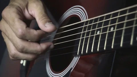 Man playing guitar on black background. Six strings. Playing with fingers Video stock 79041496