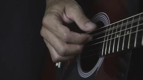 Man playing guitar on black background. Six strings. Playing with fingers Video stock 79042622