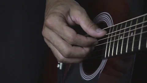 Man playing guitar on black background. Six strings. Playing with fingers Video stock 79042846