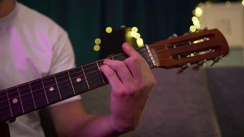 Man playing guitar close-up to hold the chord Stock Footage 129101403