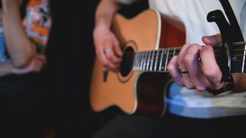 Man playing on guitar in dark room Stock Footage 147145373