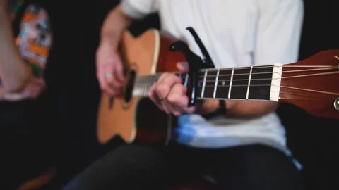 Man playing on guitar in dark room Stock Footage 147145381