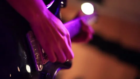 Man playing guitar inside building 스톡 동영상 290940264