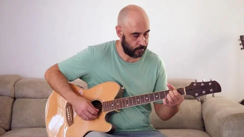 Man Playing Guitar in Medium Shot Stock Footage 284342747