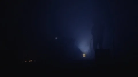 Man playing guitar moves in front of strobe lights onstage Stock Footage 127144138