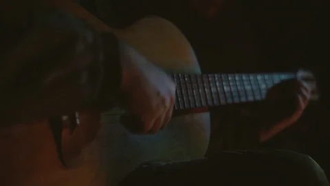 Man playing the guitar at night Stock Footage 128918767