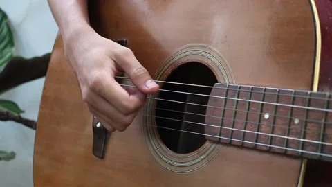 A man playing guitar in park Stock Footage 132950164