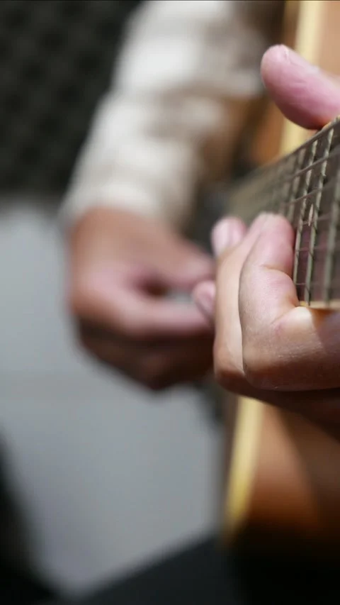 A man playing guitar. Someone strumming an acoustic guitar Stock Footage 313958095