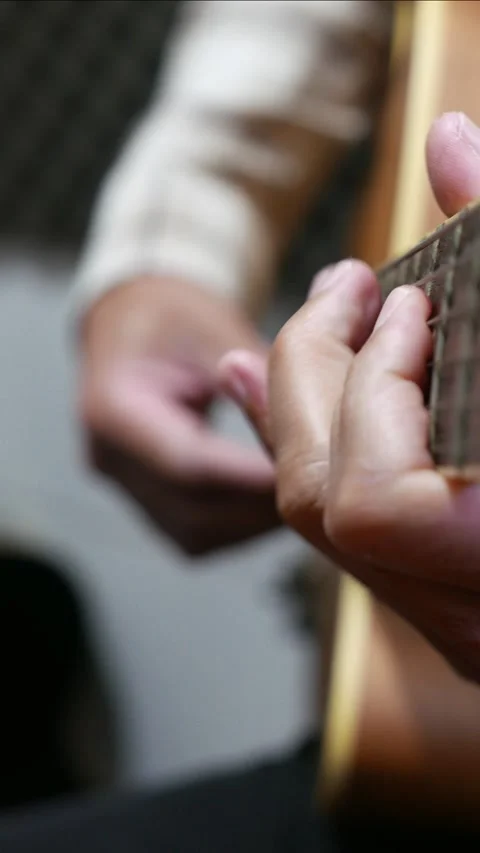 A man playing guitar. Someone strumming an acoustic guitar Stock Footage 314522368