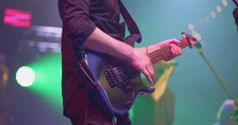 Man is playing guitar on stage. Young man playing on electric guitar. Artist Video stock 154333337