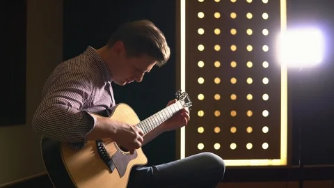 Man playing guitar in studio Stock Footage 104627720