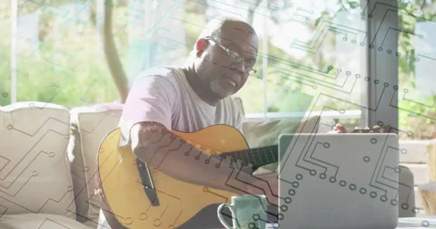 Man playing guitar while using laptop, with circuit pattern animation overlay 스톡 동영상 305122538