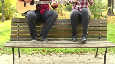 Man playing guitar while woman singing Stock Footage 59556837