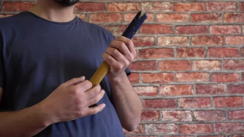 A man playing with a hammer 4K Stock-Footage 150287472